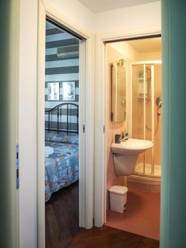 a bathroom with a sink and a bed at Amba Alagi Apartment in Genoa