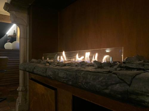 a fireplace with a bunch of lit candles on it at B&B Leonie in Alveringem