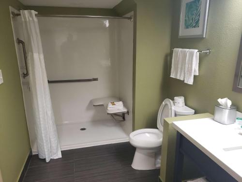 a bathroom with a shower and a toilet and a sink at Best Western Plus Sanford Airport/Lake Mary Hotel in Sanford