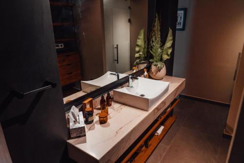 a bathroom with two sinks and a large mirror at CASA EMILIA B&B Boutique in Mexico City