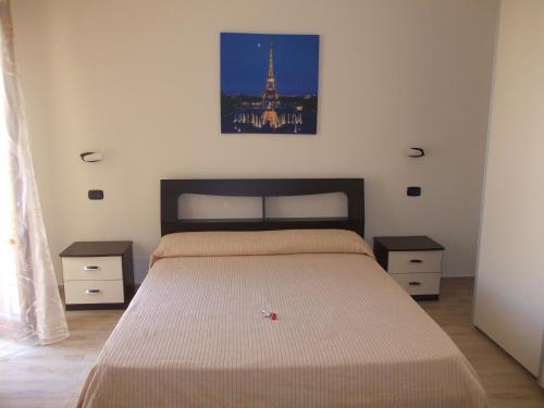 a bedroom with a bed and a picture of the eiffel tower at Bed and Breakfast Teresa Masselli in San Severo