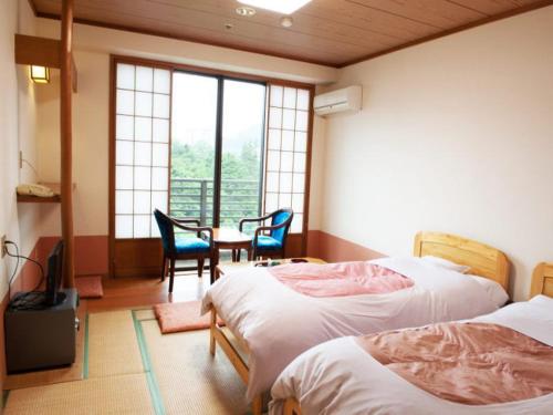 Postel nebo postele na pokoji v ubytování Hotel New Ohruri