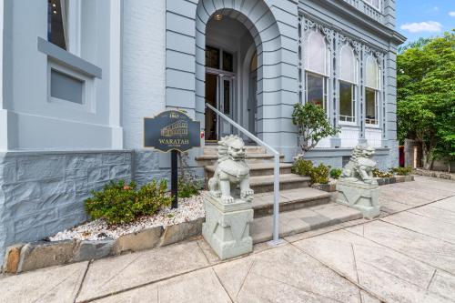 a building with two lion statues in front of it at Waratah On York in Launceston