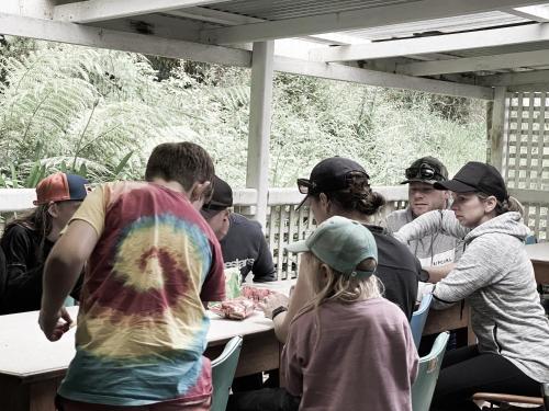 a group of people sitting at a picnic table at Mountain View Motel in Queenstown