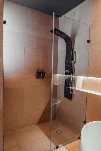 a shower with a glass door in a bathroom at CASA EMILIA B&B Boutique in Mexico City