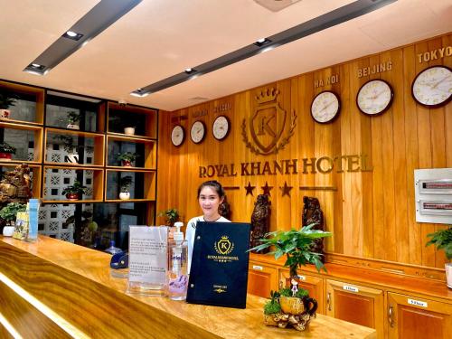 a woman is standing behind a counter in a restaurant at Royal Khanh Hotel in Tuy Hoa