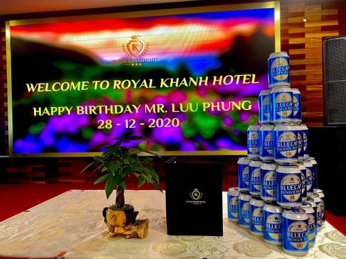 a stack of bottles of water on a table with a television at Royal Khanh Hotel in Tuy Hoa