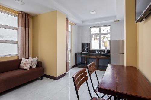 a living room with a couch and a dining room table at Botum Palace Hotel in Phnom Penh