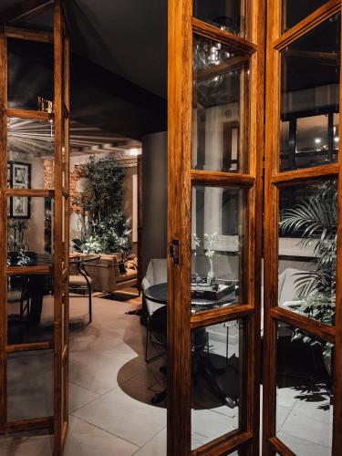 a dining room with glass doors and a table at CASA EMILIA B&B Boutique in Mexico City