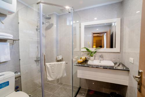 y baño con ducha, lavabo y aseo. en Hoang Hai Hotel, en Hai Phong