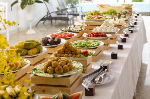 a buffet line with many plates of food on it at Casa Maya Resort in ThÃ´n Báº£o An