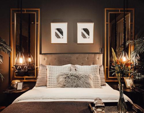 a bedroom with a bed with two pictures on the wall at CASA EMILIA B&B Boutique in Mexico City