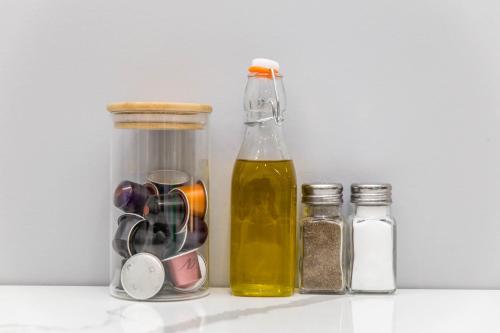 a bottle of oil next to two jars of spices at Lofts du Parc LaHaie in Montréal