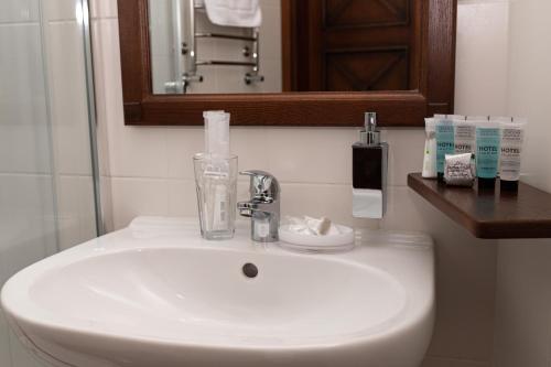 a white sink in a bathroom with a mirror at Ekaterinoslav in Dnipro