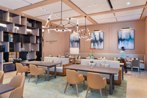 a rendering of a restaurant with tables and chairs at Address Beach Resort in Dubai
