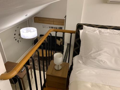 a bedroom with a bed and a stair railing at Casa Ercoli PONTORMO in Empoli