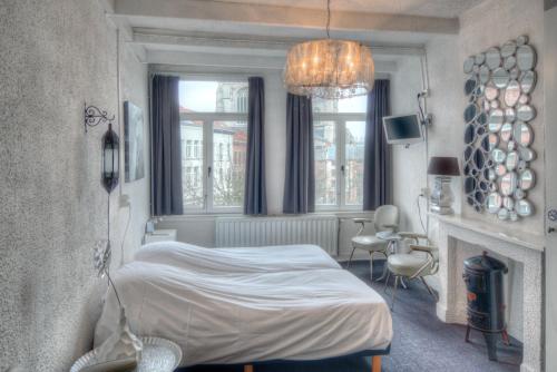 En eller flere senger på et rom på Hotel Urban Dreams