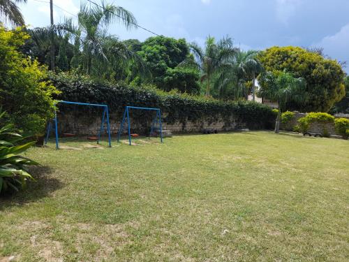 a field with two blue nets in a yard at Royal Palms Apartment D4 - Mtwapa in Mtwapa