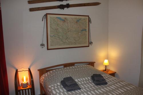 a bedroom with a bed and a map on the wall at Appartement Le Savoisien in Chamonix