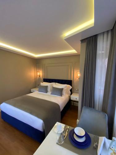 a hotel room with two beds and a dining table at Ozkaya Apartments Galata in Istanbul