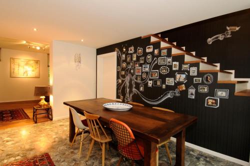 a dining room with a table and a staircase at Lärchenhof in Afritz