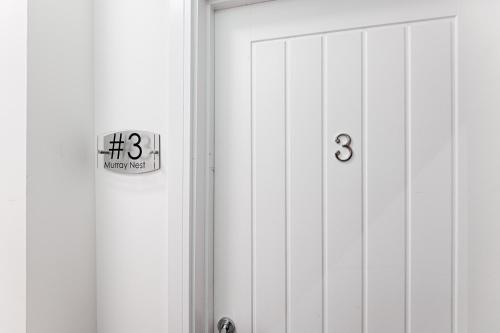 a white door with a sign on the side of it at 3RM Flat, Smart Tv's, close to all amenities in Llanelli