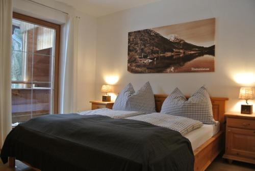 a bedroom with a bed and a large window at Appartement Seespitzhof in Scheffau am Wilden Kaiser