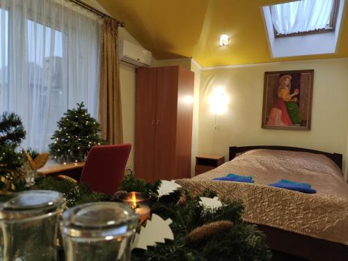 a bedroom with a bed and christmas decorations on a table at Malva in Lviv