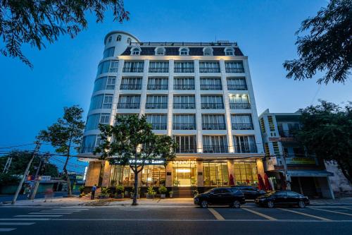 a tall building with cars parked in front of it at Aquatel Vung Tau in Vung Tau