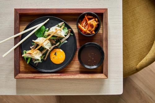 a tray with a plate of food with an egg and other food at Erinvale Estate Hotel & Spa in Somerset West