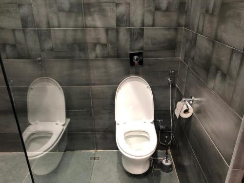 a bathroom with a toilet and a bidet at Palm Kalash Hotel in Lusaka
