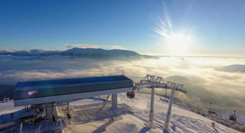 a ski lift on top of a snow covered mountain at Apartmán B13 Tatran Donovaly in Donovaly