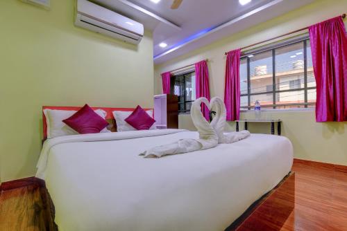 a bedroom with two beds with a bunny made out of towels at HOTEL HARBOUR VIEW in Port Blair