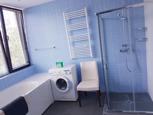 a bathroom with a washing machine and a washer at Zlaten Briz Villa in Osenovo