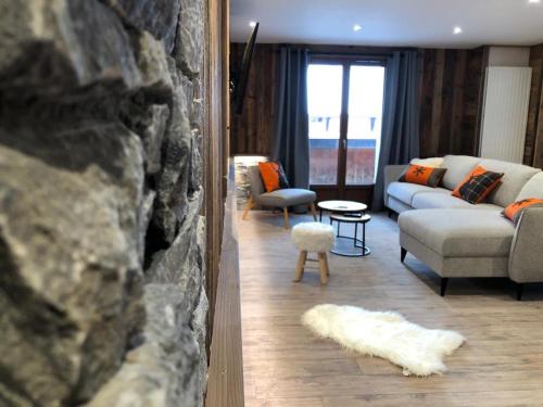 a living room with a couch and a fireplace at Résidence Julianna , trajets remontées mécaniques , livraison viennoiseries, piscine couverte in Morzine