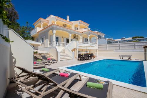 a villa with a swimming pool and a house at Villa Casa Castelo by Algarve Vacation in Albufeira