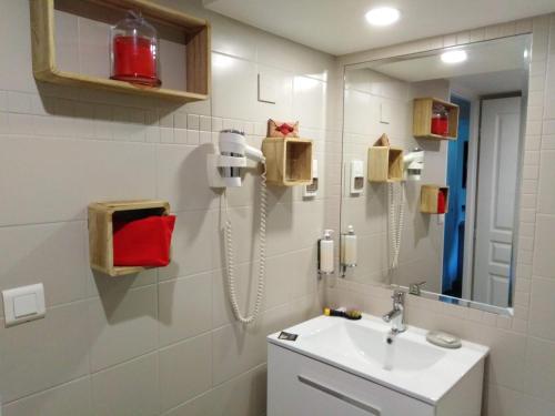 a bathroom with a sink and a mirror at Hôtel Picardia in Saint-Valery-sur-Somme
