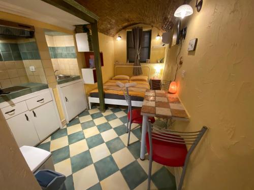 una pequeña cocina con mesa y sillas en una habitación en Cosy Little Love Nest in Piran, en Piran
