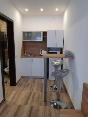 a kitchen with a counter and a stool in a room at Villa Anela in Pasuljište