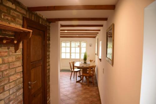 a hallway with a table and a brick wall at Ferienwohnung/Haus in Welzin in Damshagen