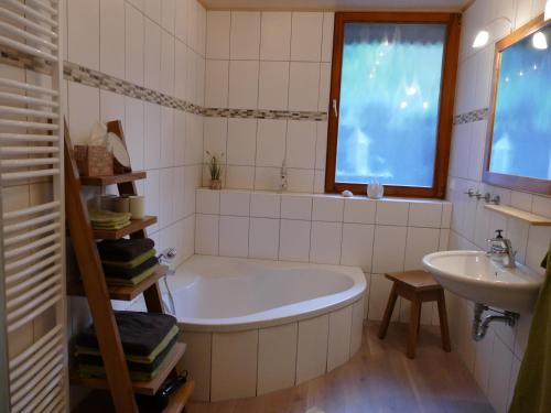 a bathroom with a tub and a sink at Ferienwohnung Lichtblick in Friesenheim