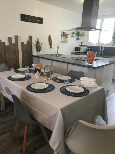 - une table avec un chiffon blanc dans la cuisine dans l'établissement Maison 4 chambres jardin et parking, à Déols