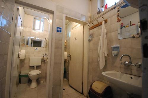 a small bathroom with a toilet and a sink at Yo Ho Hostel in Varna City