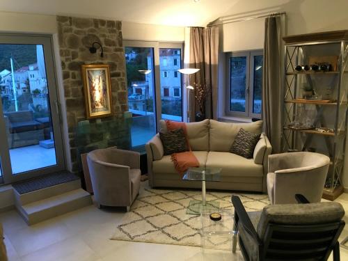 a living room with a couch and a glass table at High View-A Seaside Villa With Huge Jacuzzi in Račišće