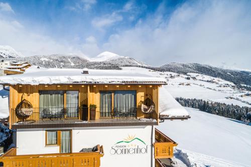 a house on top of a snow covered mountain at Pension Sonnenhof in Maranza