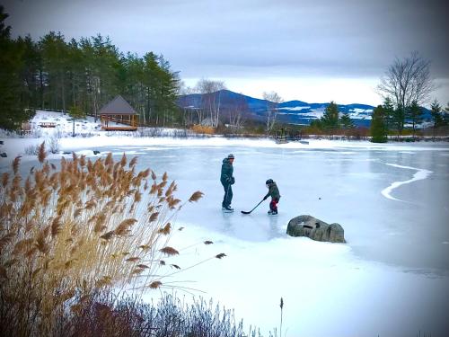 two people are skiing on a frozen lake at Domaine Gagnon in Saint Sebastien