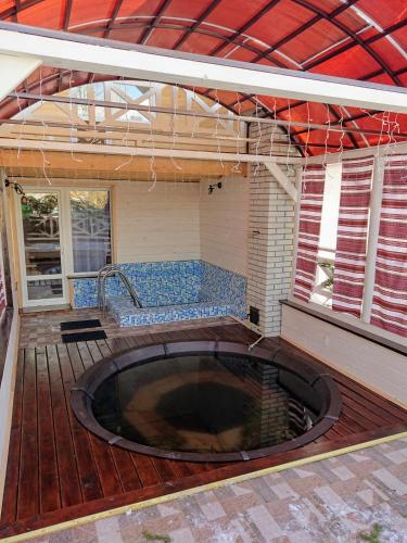 a large hot tub on a deck with a patio at Hollywood in Yaremche