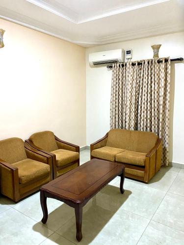 a living room with two chairs and a table at Nue-Crest Hotels & Suites in Enugu