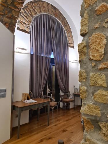 a room with a table and a window with purple curtains at Incantevole con Jacuzzi in Rome
