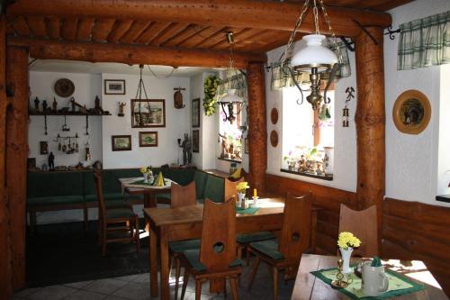 a dining room with wooden tables and chairs and a dining room at Apartment-in-Wiesa in Thermalbad Wiesenbad